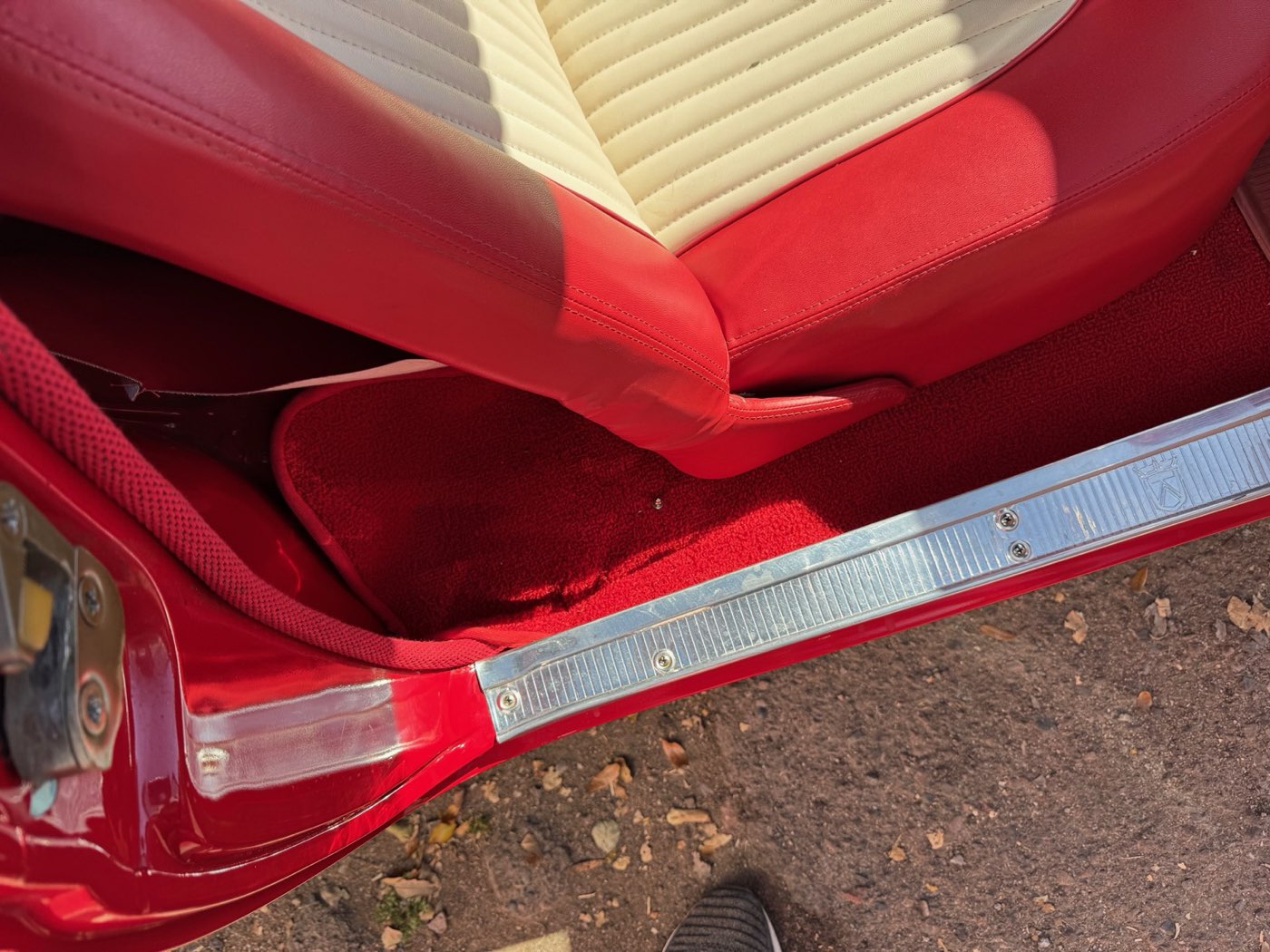 Detail of red and white leather seat reupholstery in a classic Thunderbird