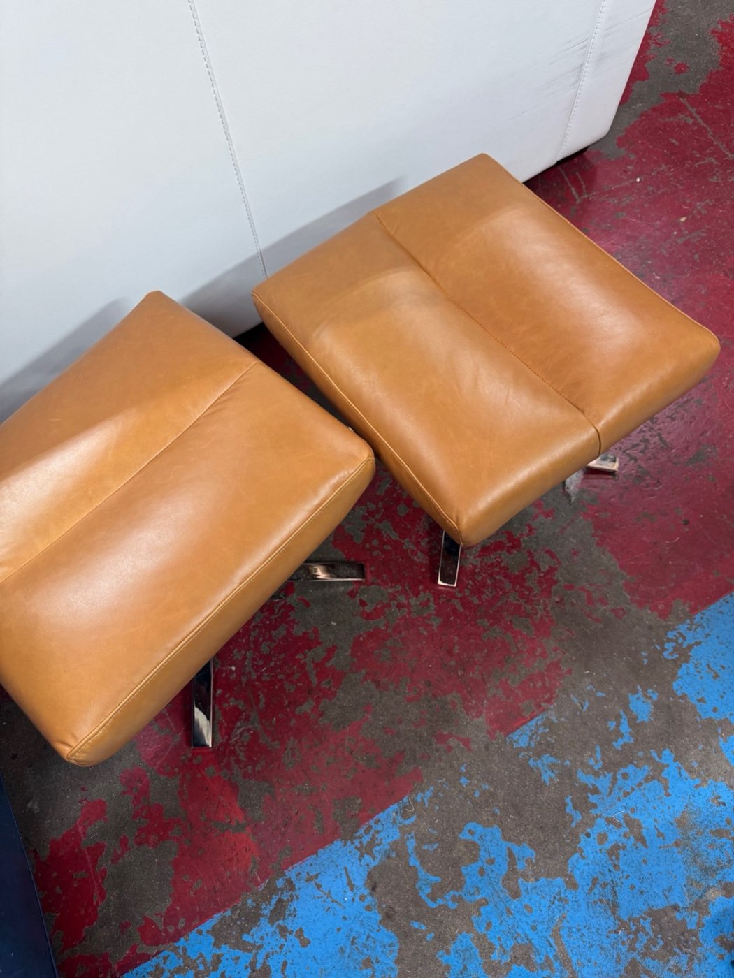 Cognac leather ottomans reupholstered by American Upholstery