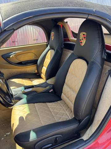 After: black and tan quilted sports car seats with embroidered crest