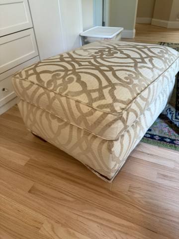 After: cream and gold trellis ottoman on wood floor