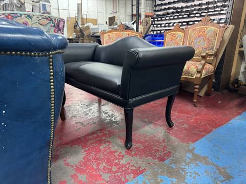 After: black leather settee with carved legs