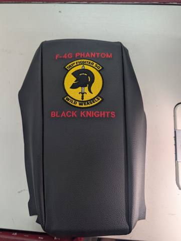 After: black vinyl armrest with embroidered squadron patch