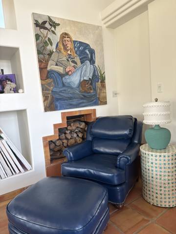After: navy leather club chair and ottoman in living room