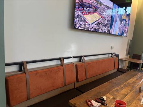 After: orange suede wall-mounted back cushions in restaurant
