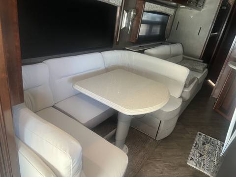 After: white U-shaped RV dinette with table