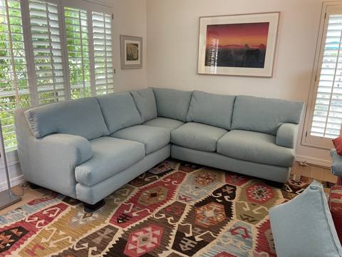 After: light blue sectional sofa in sunny living room