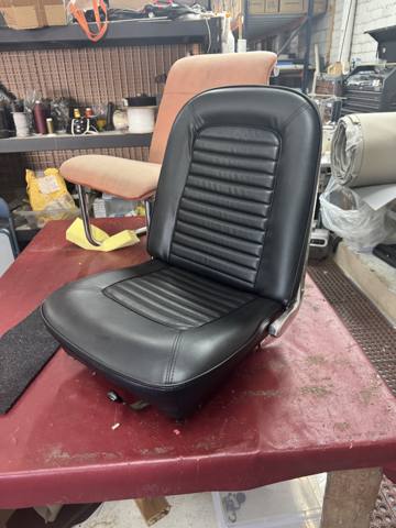 After: classic black pleated bucket seat on workbench