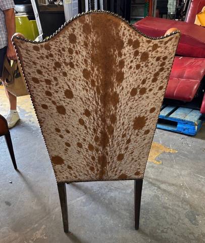 After: cowhide back of wingback chair with nailheads