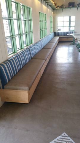 After: long striped banquette along restaurant windows