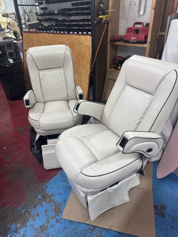 After: two cream RV captain chairs with piping, finished